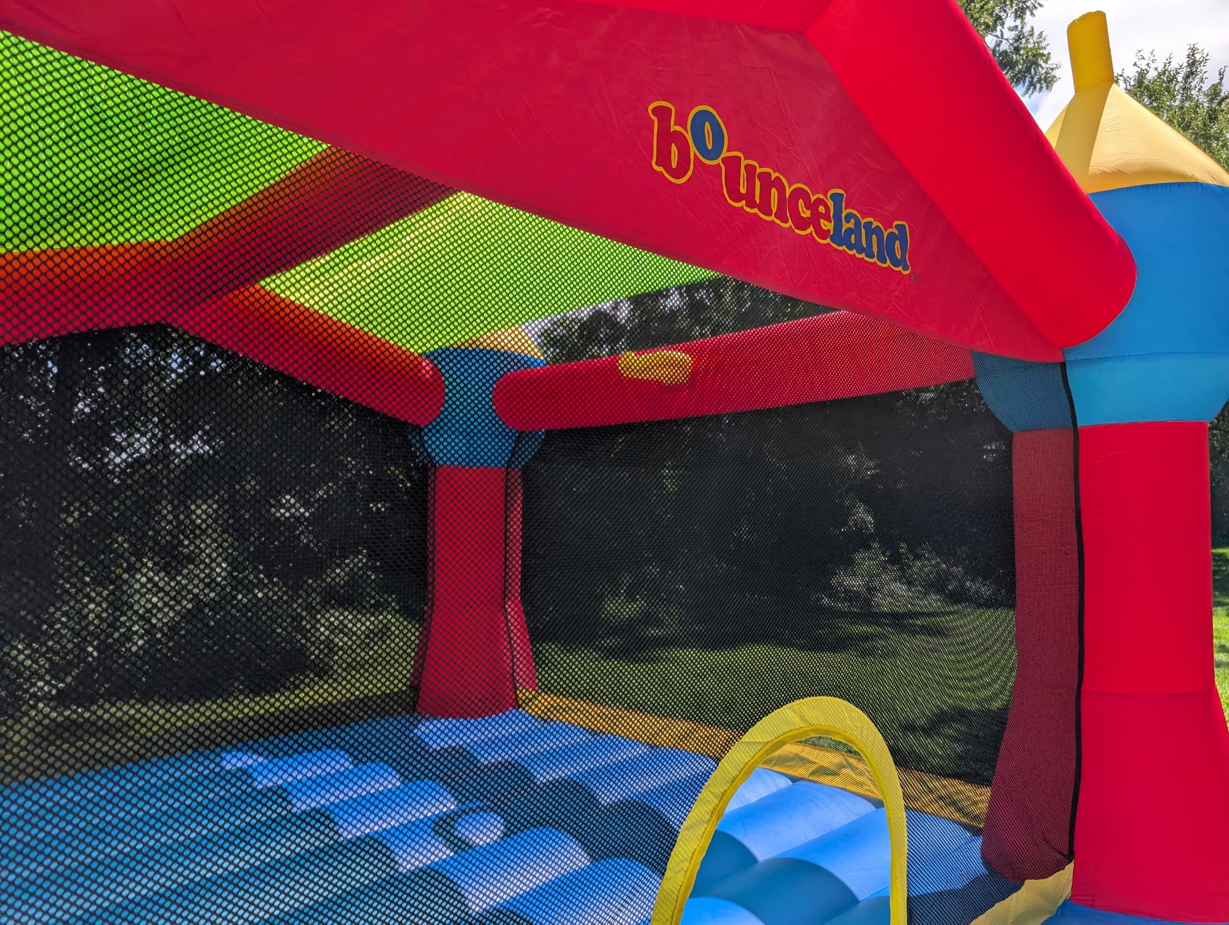 Inside the bounce house, showing the slide and mesh walls