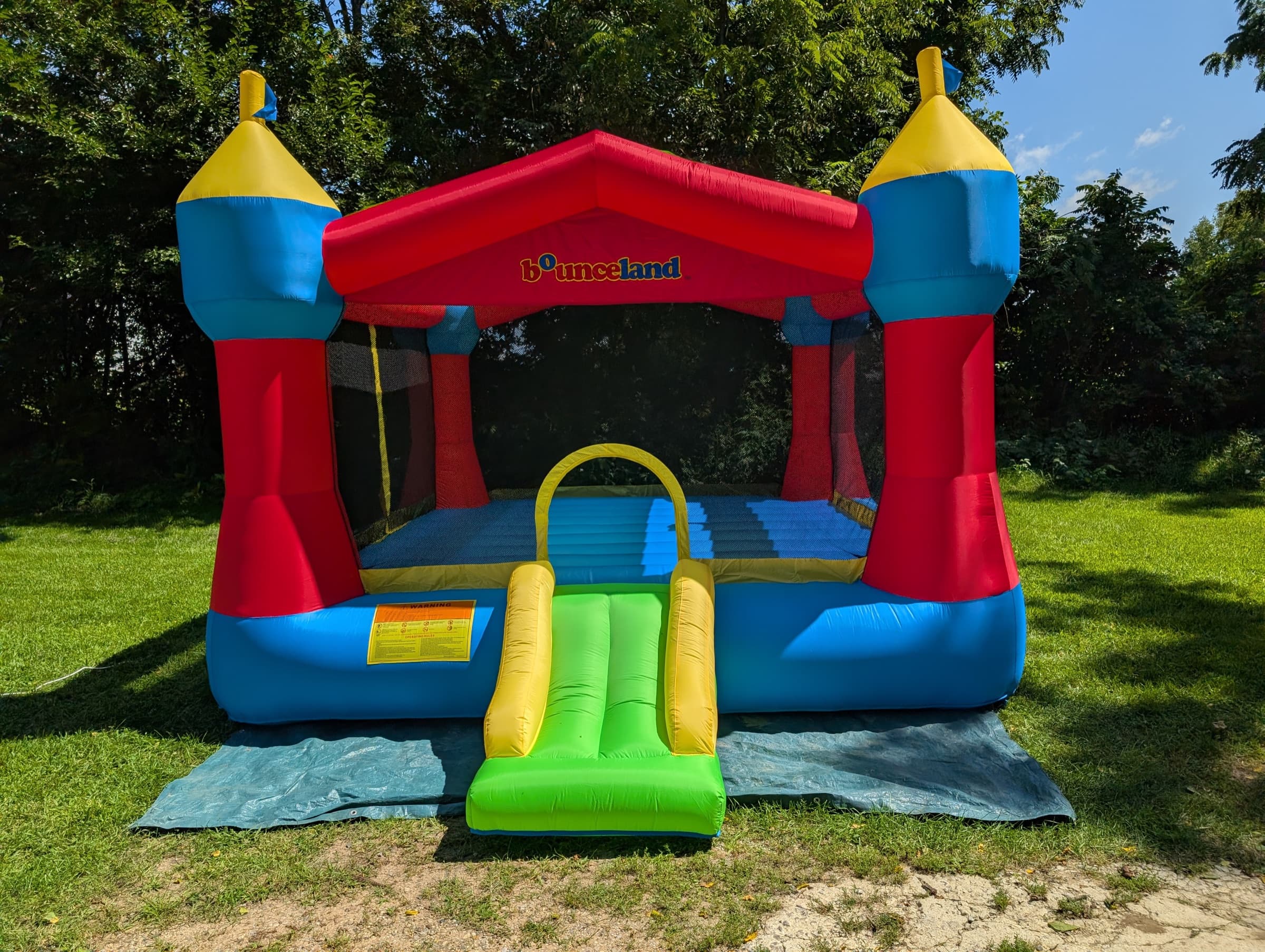 Inflatable party castle bounce house set up on a lawn